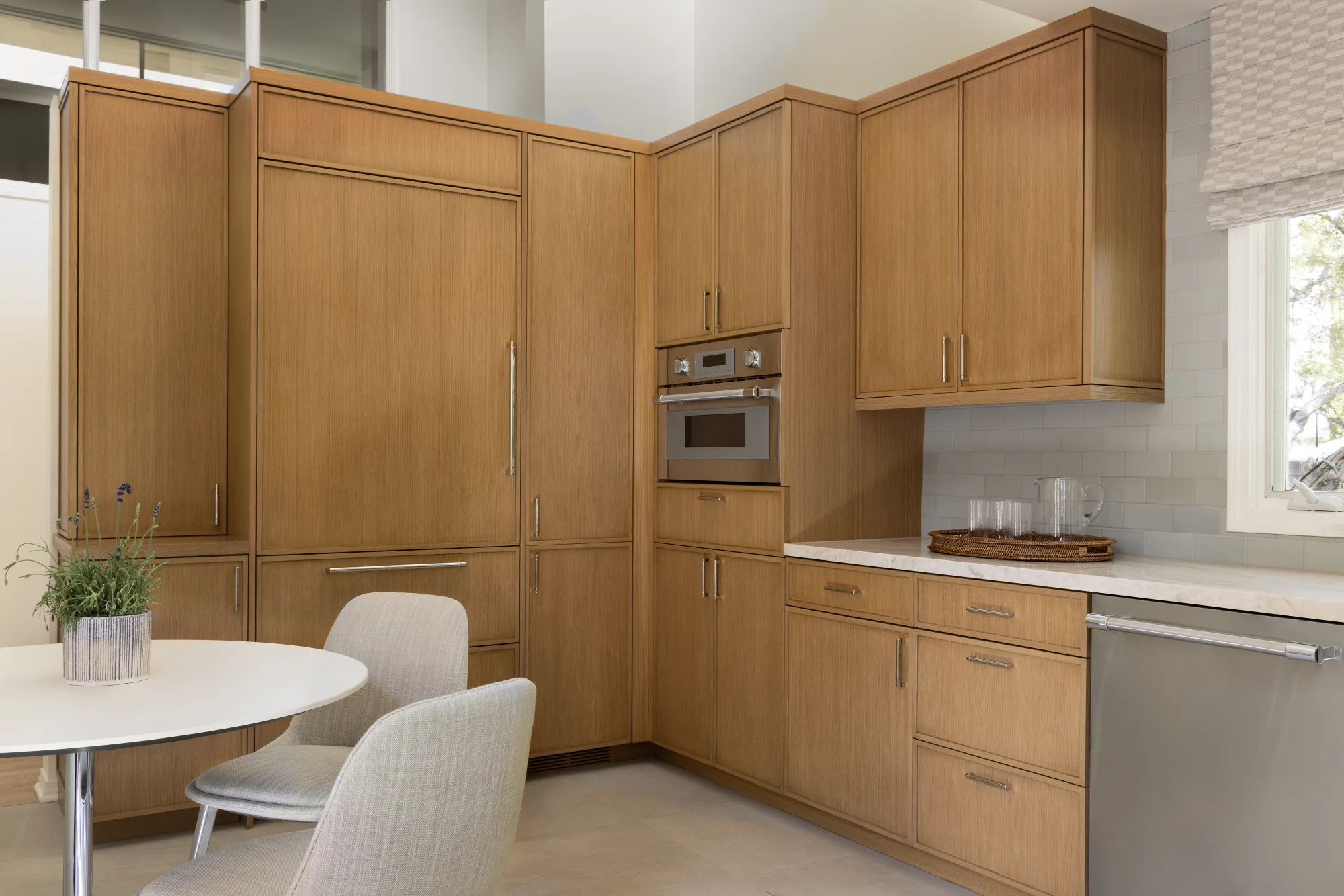 Kitchen corner with floor-to-ceiling oak cabinets and a round breakfast table