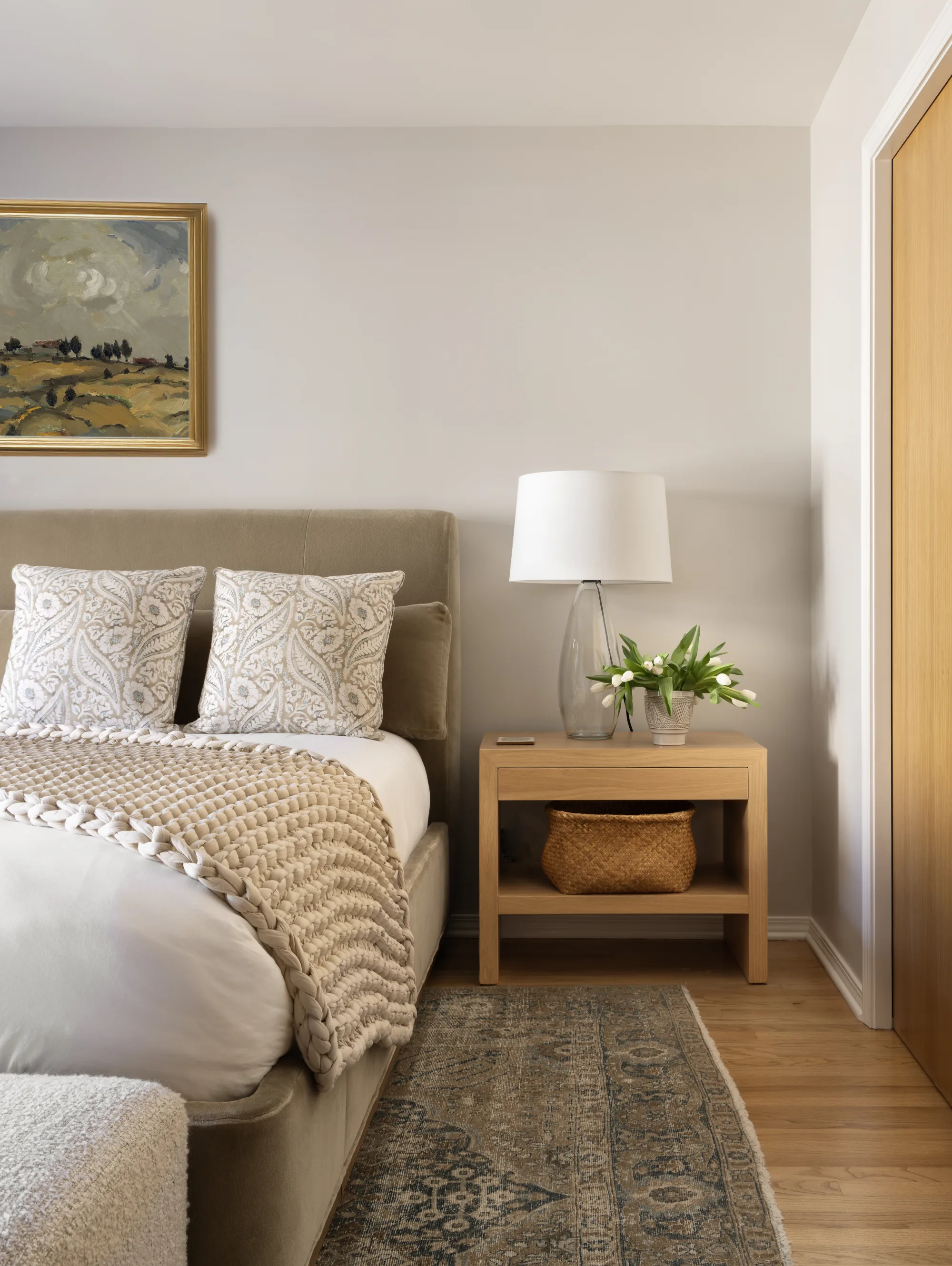 Bedroom with an upholstered bed, an oak nightstand and a vintage runner