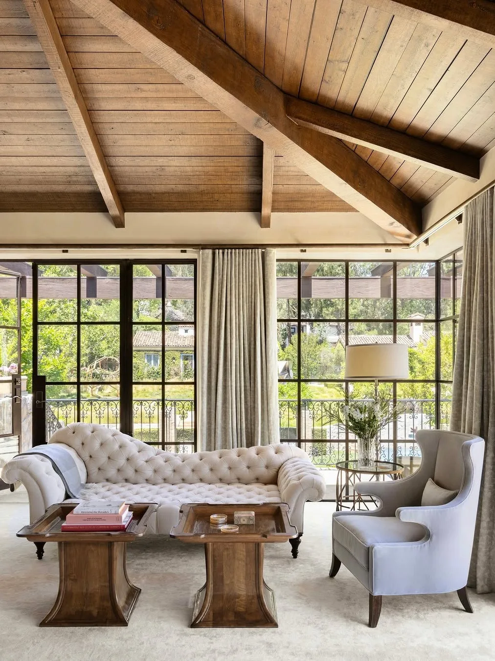 Living room under a vaulted wood-beam ceiling in a Hidden Hills home